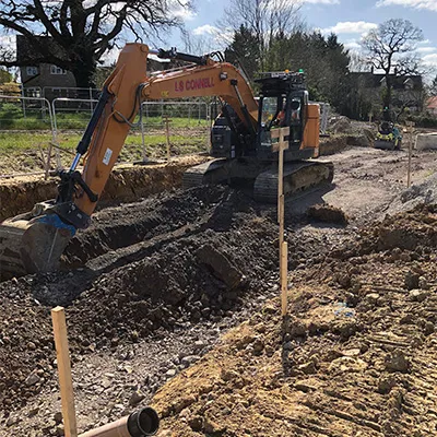 a digger digging dirt during daytime