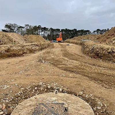 a dirt road with a drain