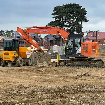 an orange digger next to a yellow one